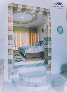 a bedroom with a bed and a large mirror at Valentina Apartments in Gevgelija