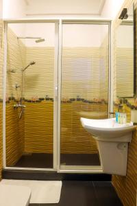 
a bathroom with a sink, toilet and shower stall at Randiya Sea View Hotel in Mirissa
