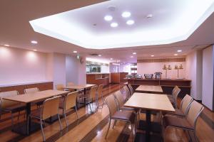 a dining room with wooden tables and chairs at Hotel Promote Hakodate in Hakodate