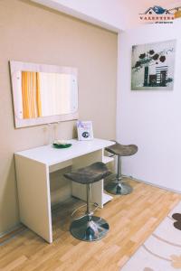 a room with a white desk and two stools at Valentina Apartments in Gevgelija