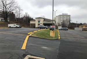 an empty parking lot with a for sale sign in the middle at Economy Inn in Moon