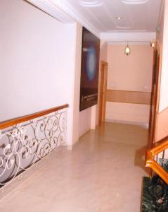 a hallway with a metal railing in a house at Hotel King in Haridwār