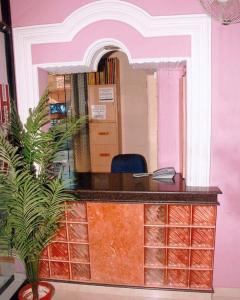 a desk in an office with a potted plant at Hotel King in Haridwār