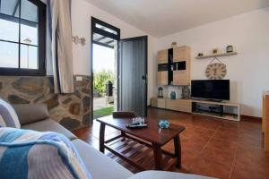 a living room with a couch and a table at Buda in Tinajo