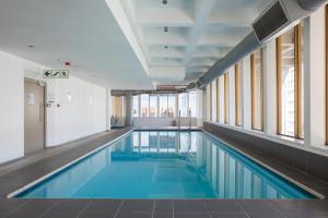 a swimming pool in a building with windows at #1803 Cartwright - Simply Spectacular in Cape Town