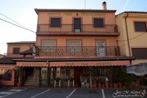 a building with a balcony on top of it at Hostal Restaurante El Final in El Cabaco