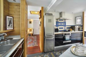 a kitchen with a refrigerator and a sink at Appartement Mogador in Honfleur