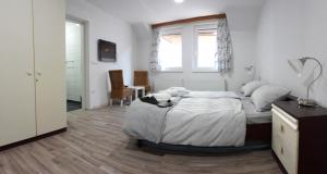 a bedroom with a bed with a stuffed animal on it at Apartments&Rooms Mido in Visoko