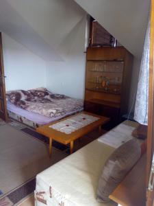 a room with two bunk beds and a table at Apartmán Monika in Veľký Meder