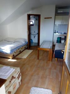 a room with two beds and a table in it at Apartmán Monika in Veľký Meder