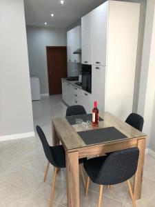 a kitchen with a wooden table and chairs at 27A in Marsalforn