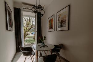 a dining room with a table and chairs and a window at BIKE ROOMS in Przemyśl