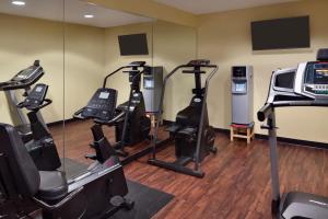 a gym with several treadmills and elliptical machines at Hawthorn Extended Stay by Wyndham Milwaukee Airport in Milwaukee