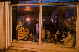 a painting of a room with figurines of people at The Historic Wolf Hotel in Ellinwood