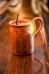 an orange mug with a slice of lime in it at The Historic Wolf Hotel in Ellinwood