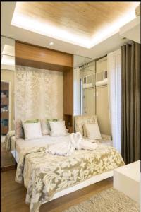 a bedroom with a large bed in a room at Sta.Mesa across SM Model Unit 2 BR in Manila