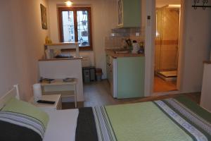 a room with a kitchen and a bed in a room at Apartments Jago in Piran