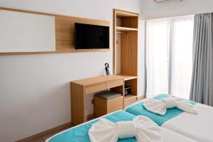 Voodi või voodid majutusasutuse Pyramos Hotel toas