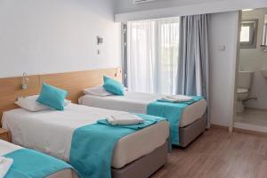 Voodi või voodid majutusasutuse Pyramos Hotel toas