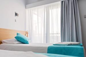 Voodi või voodid majutusasutuse Pyramos Hotel toas