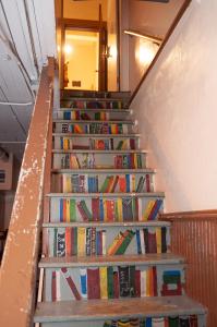 a bunch of books sitting on the stairs at The Historic Wolf Hotel in Ellinwood