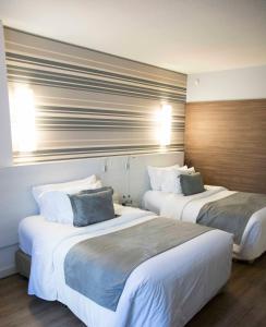 Postel nebo postele na pokoji v ubytování Radisson Hotel Curitiba