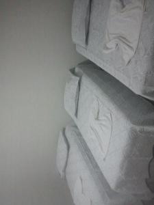 a close up of a bed with white sheets at Hotel Aracaju Express in Aracaju
