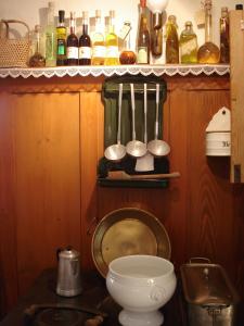a kitchen with a counter with utensils on a shelf at Hotel Restaurant Peterle in Feldberg
