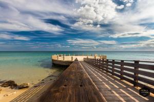 a wooden pier stretches out into the ocean at Hybla Major B&B in Avola