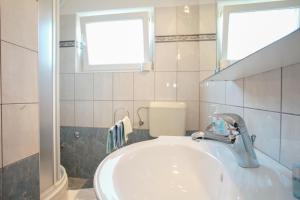 a bathroom with a sink and a window at Rooms & Apartment Albina in Baška +69 photos