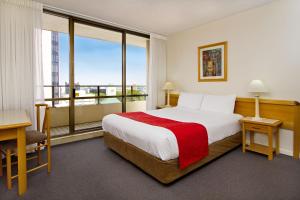 a hotel room with a bed and a large window at Summit Apartments Brisbane City in Brisbane +21 photos