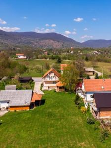 an aerial view of a village with houses and green grass at House Marijana in Smoljanac