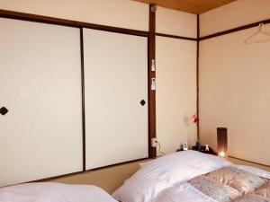 Postel nebo postele na pokoji v ubytování Suzume-An