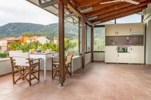 a kitchen and dining room with a table and chairs at Xenia in Iraklitsa