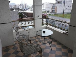 a table and two chairs on a balcony at 花沐嵐民宿 in Taitung City