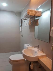 a bathroom with a sink and a toilet and a mirror at 9 Square Hotel - Petaling Jaya in Kota Damansara