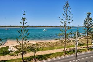 a view of a beach with a boat in the water at Bayview Beach Holiday Apartments in Gold Coast