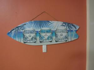 a blue and white surfboard hanging on a wall at Meekatharra Outback Beach House in Meekatharra