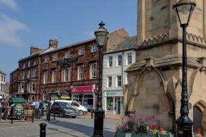 a city street with buildings and a street light at The George Hotel in Penrith