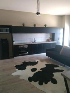 a living room with a cow rug on the floor at Kindred Parkside Apartments in Leeton