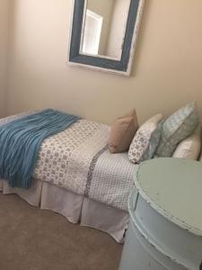 a bedroom with a bed with a mirror on the wall at Kindred Parkside Apartments in Leeton