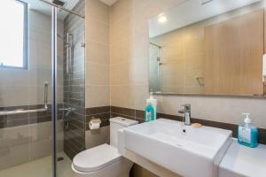 a bathroom with a sink and a toilet and a shower at TeeUp Home - Infinity Pool Signature in Ho Chi Minh City +151 photos