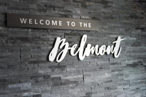 a brick wall with a welcome to the bathroom sign at Belmont Llandudno in Llandudno