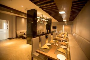 a long dining room with a long table and chairs at S Hotels Chennai in Chennai