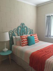 a bedroom with a bed with colorful pillows at Kindred Lodge Apartments in Leeton