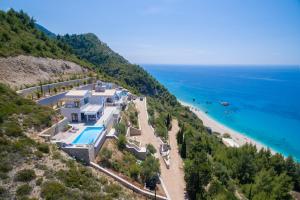 an aerial view of a house on a hill next to the ocean at Kathisma Bay Villas - Luxury Villas- Villa Oceanos in Kalamitsi