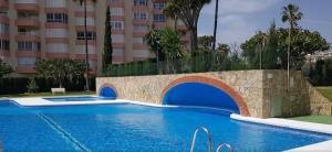 a swimming pool in front of a building at Apartamento Luz del Mar in Torrox Costa