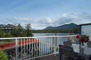 a balcony with a view of a lake and mountains at Bayshore Waterfront Inn in Ucluelet