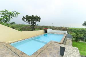 a swimming pool on the side of a house at Villa Kangen Omah in Mojokerto