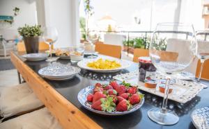 a table topped with plates of food and wine glasses at Casa Bianca - Good Living in Preveza